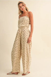 Beige ditsy floral sleeveless lace edge jumpsuit with thin spaghetti straps and drawstring waist