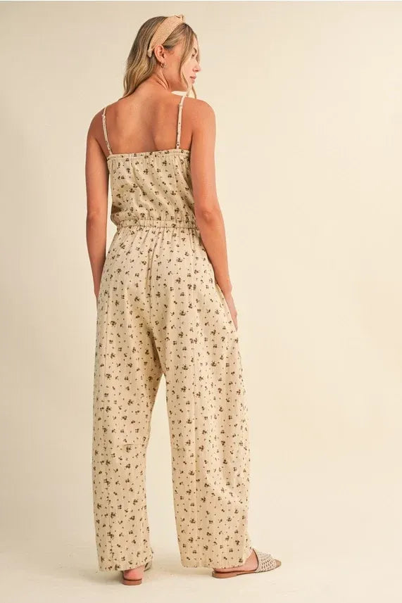 Beige ditsy floral sleeveless lace edge barrel jumpsuit with thin spaghetti straps and relaxed wide-leg silhouette