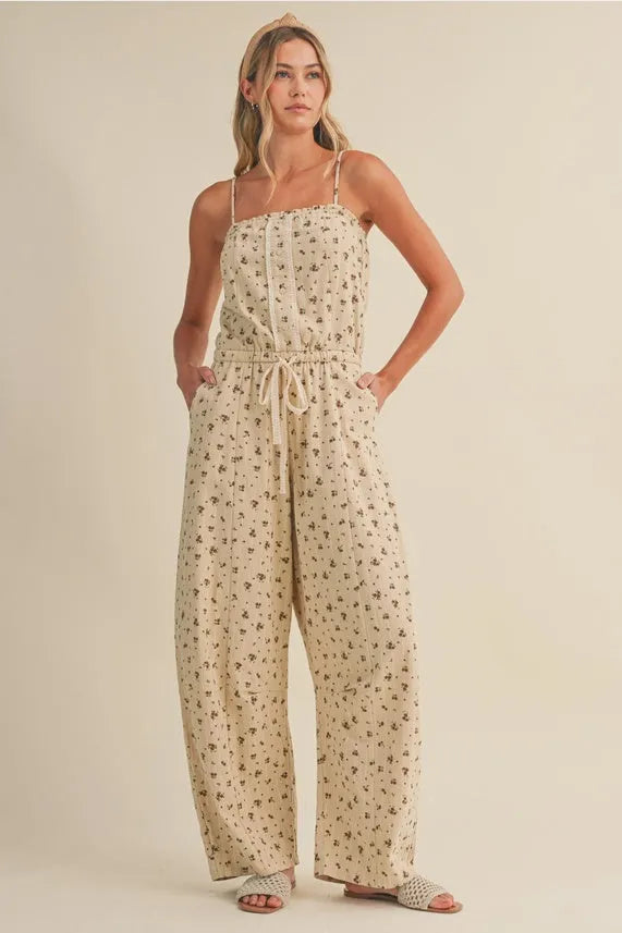 Beige ditsy floral sleeveless lace edge barrel jumpsuit with thin straps and drawstring waist
