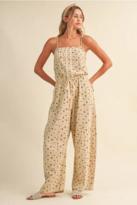 Beige ditsy floral sleeveless lace edge barrel jumpsuit with thin spaghetti straps and drawstring waist
