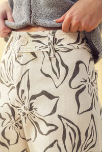 Beige floral print stretch wide leg pants with bold black patterns