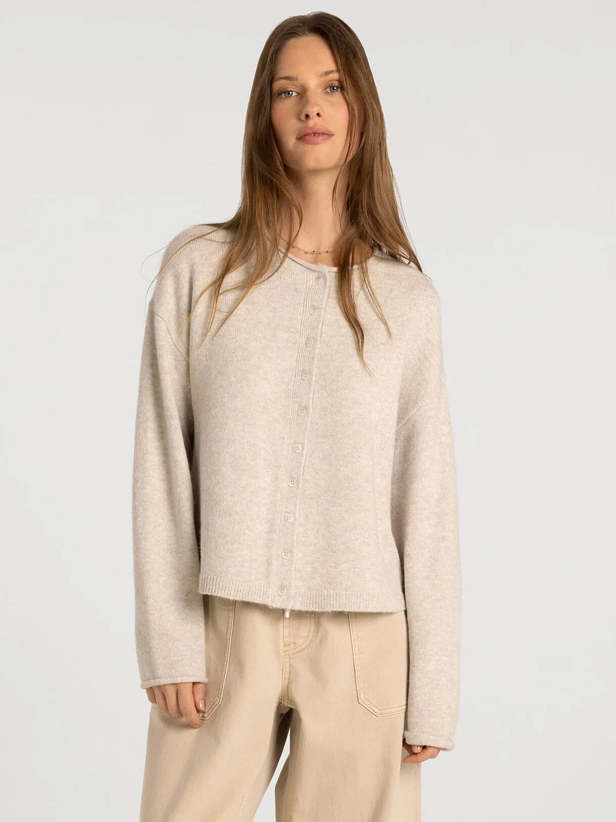 Beige knit button-up cardigan with soft textured fabric and relaxed fit from thread and supply dover button collection