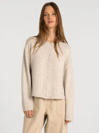 Beige knit button-up cardigan with soft textured fabric and relaxed fit from thread and supply dover button collection