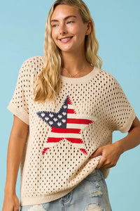 Beige usa star patch open knit sweater top with perforated pattern and large red white and blue star design with hearts