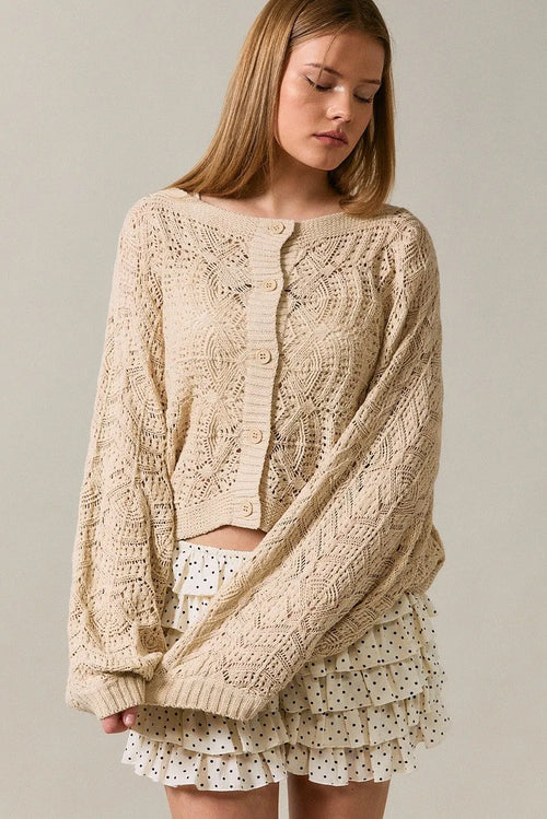 Beige long sleeve crochet cardigan with intricate cable and lace patterns in knitted fabric