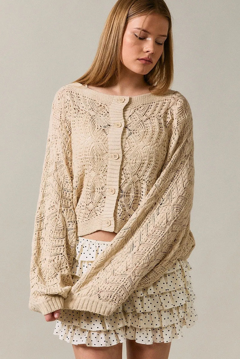 Beige long sleeve crochet cardigan with intricate cable and lace patterns in knitted fabric