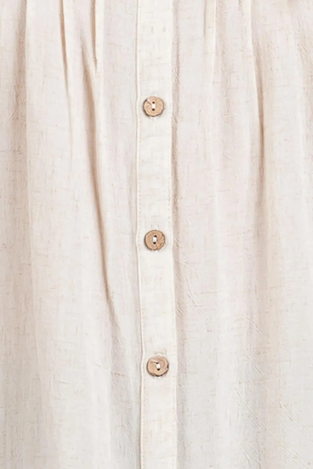 Beige linen pintuck detailed button down shirt featuring wooden buttons down the front for a classic look