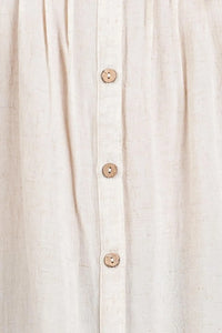 Beige linen pintuck detailed button down shirt featuring wooden buttons down the front for a classic look