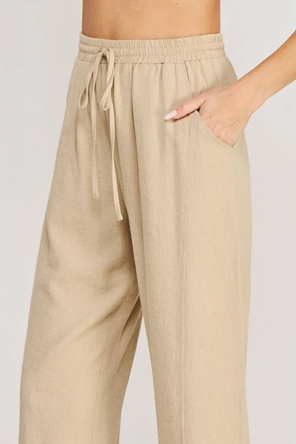 Beige rayon linen blend relaxed tapered pants with a wide-leg cut and side pockets for comfortable wear
