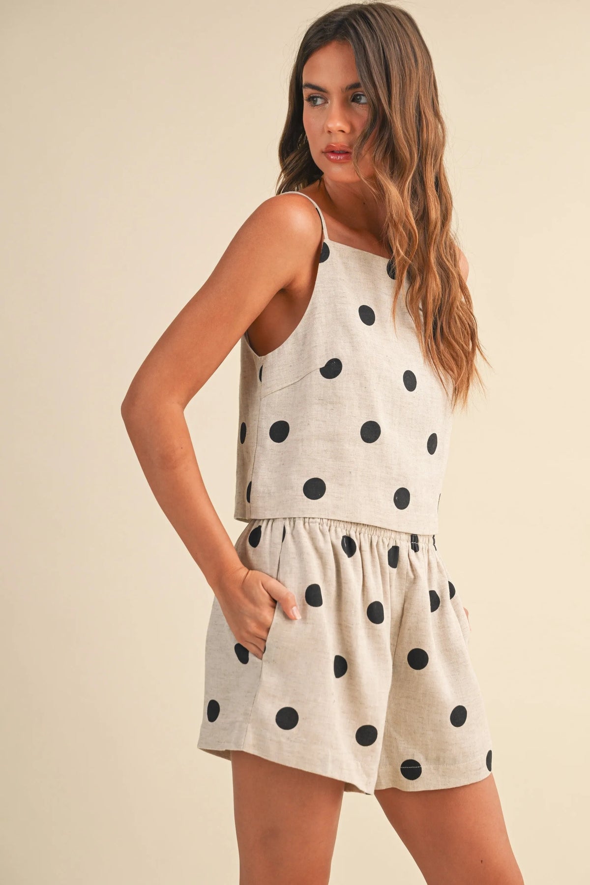 Beige polka dot linen short romper with black dots and gathered waist for casual summer wear