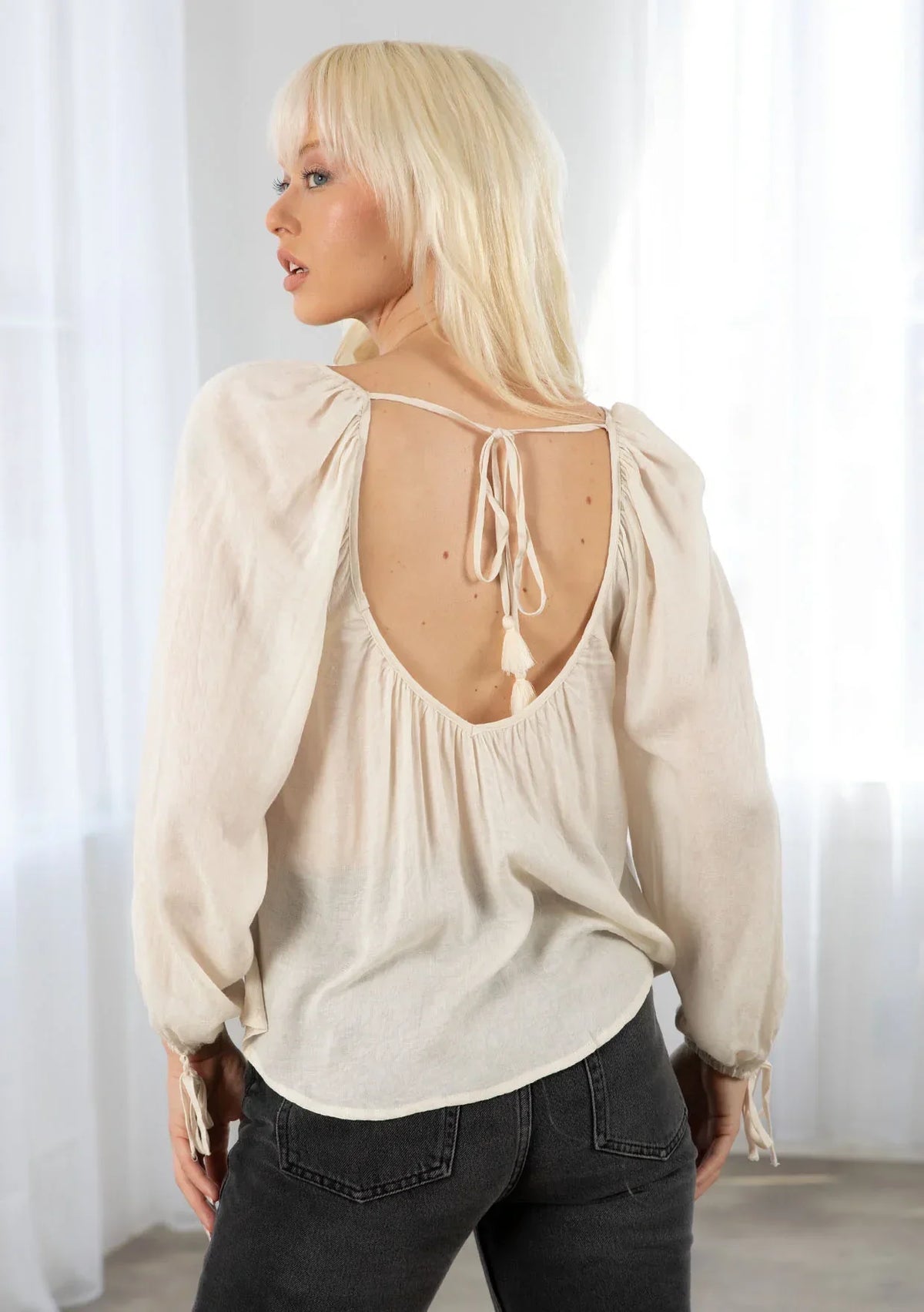 Bohemian long sleeve V neck floral top with beige puff sleeves and back tie