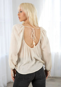 Bohemian long sleeve V neck floral top with beige puff sleeves and back tie