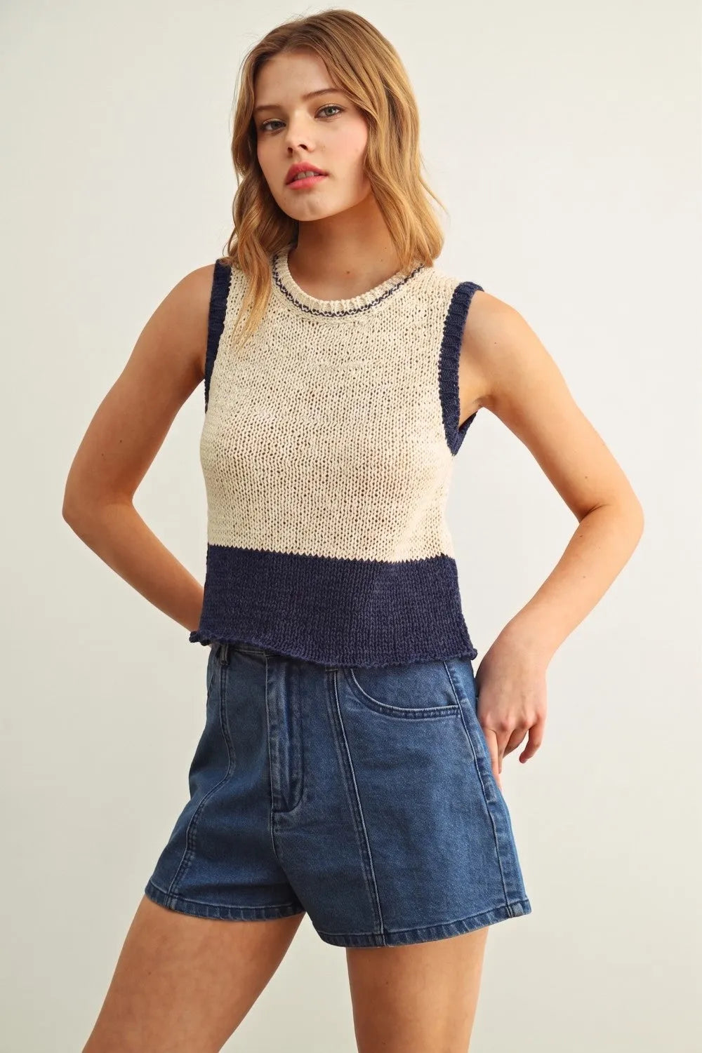 Beige and navy color blocked sleeveless knitted top with textured ribbed hem for stylish casual wear