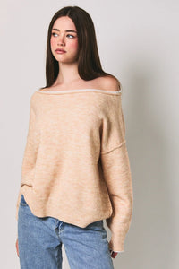 Beige off-the-shoulder knit sweater with soft textured fabric and ribbed cuffs featuring a contrast trim boat neck