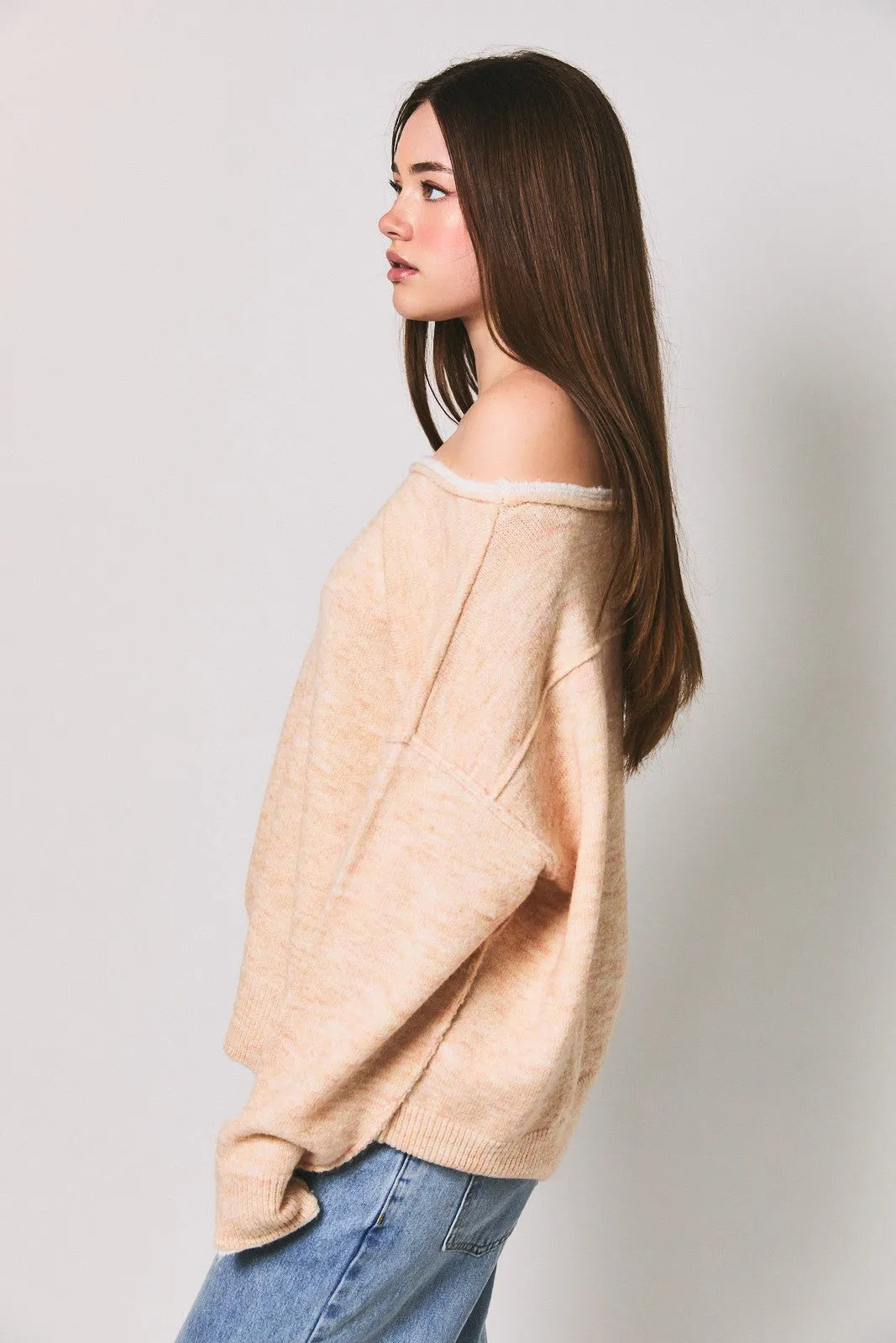 Beige off-the-shoulder knit sweater featuring a soft loose fit ribbed hem and contrast trim boat neck design