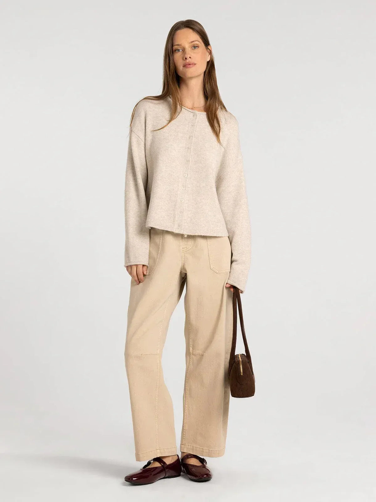 Beige oversized knit cardigan with button front and relaxed fit from supply dover button collection