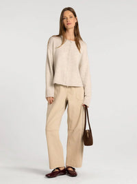 Beige oversized knit cardigan with button front and relaxed fit from supply dover button collection