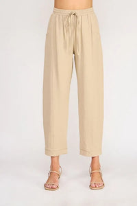 Beige rayon linen blend relaxed tapered pants with drawstring waist and rolled cuffs for comfortable wear