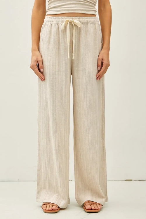Beige linen wide leg pants with pleated design and drawstring waistband from striped touch collection