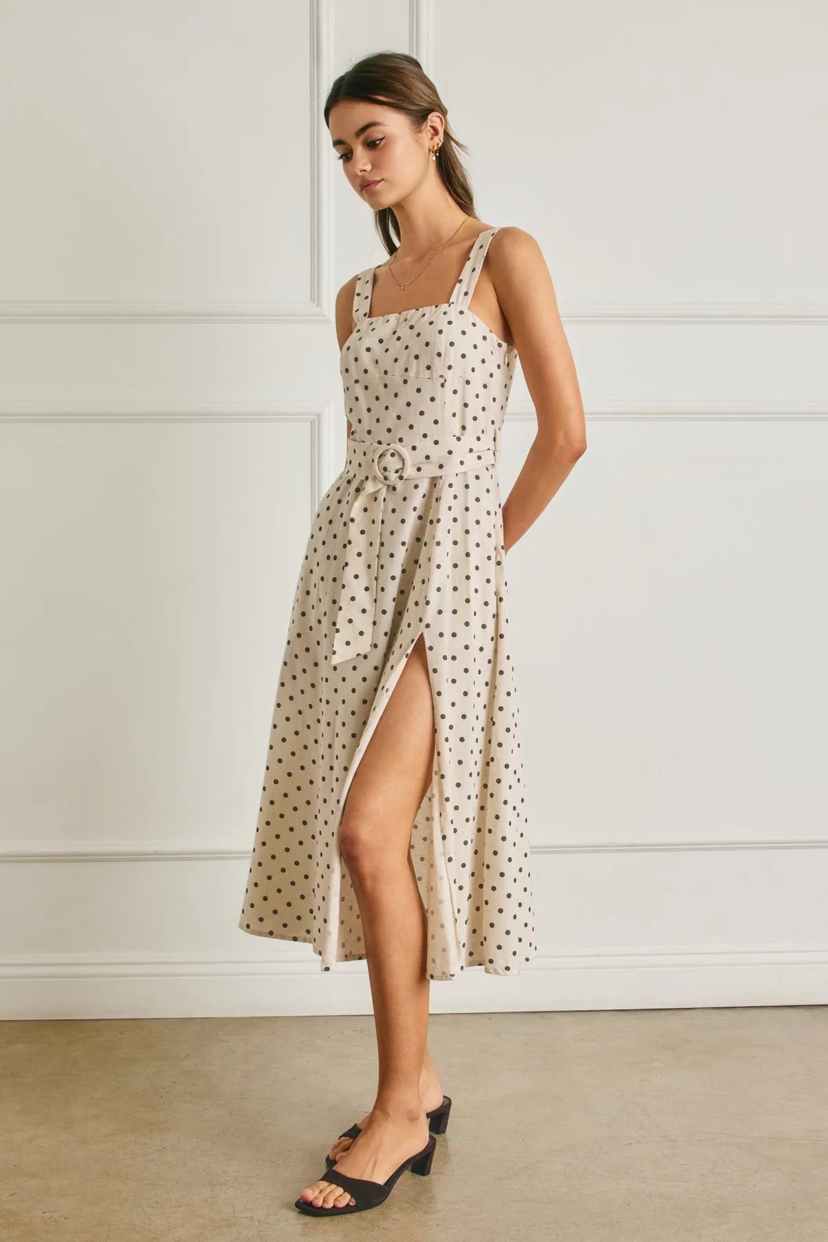 Beige polka dot linen midi dress with a square neckline, thin straps, and a buckle belt at the waist