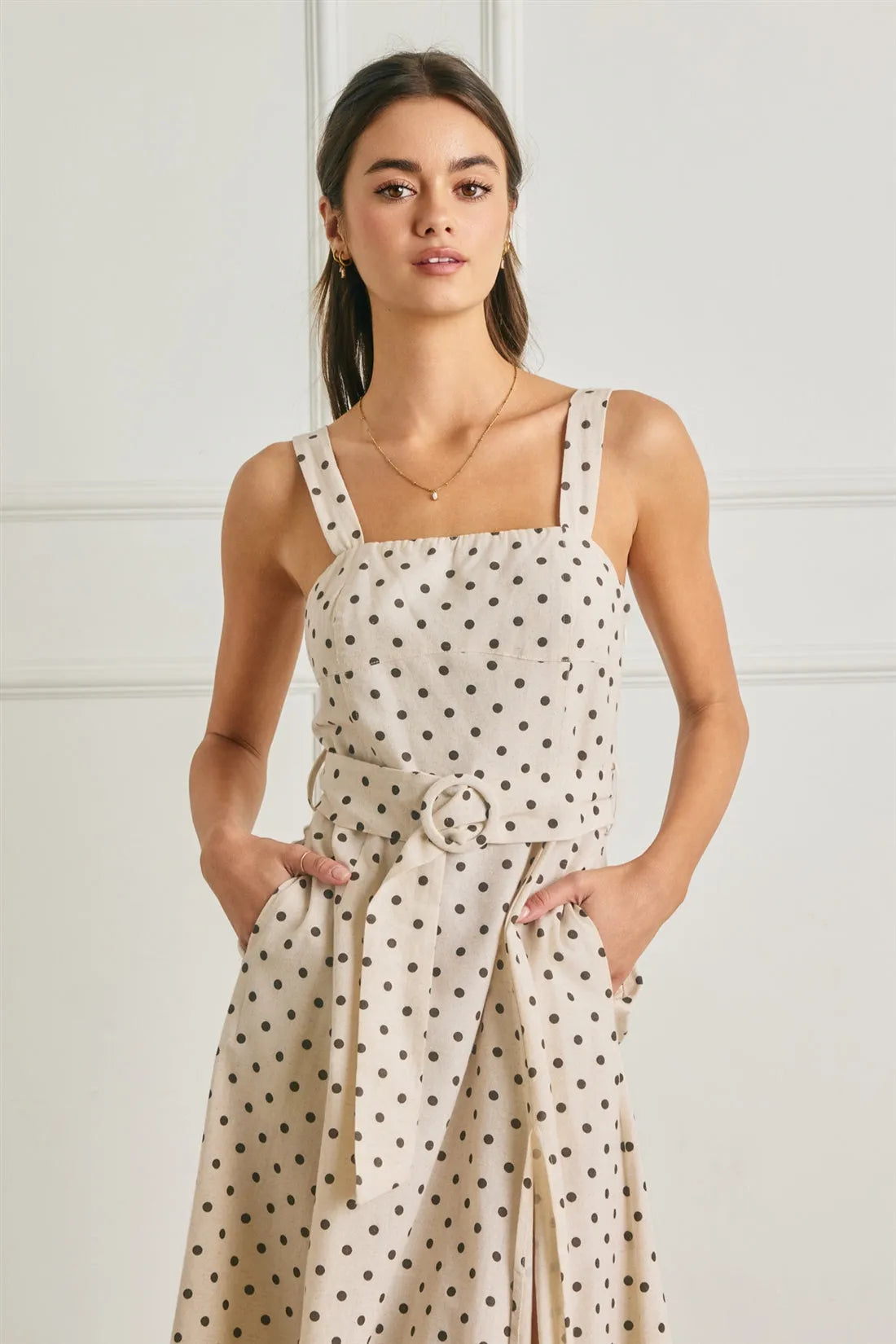 Beige polka dot linen midi dress with thin straps and a buckle belt for a stylish summer look