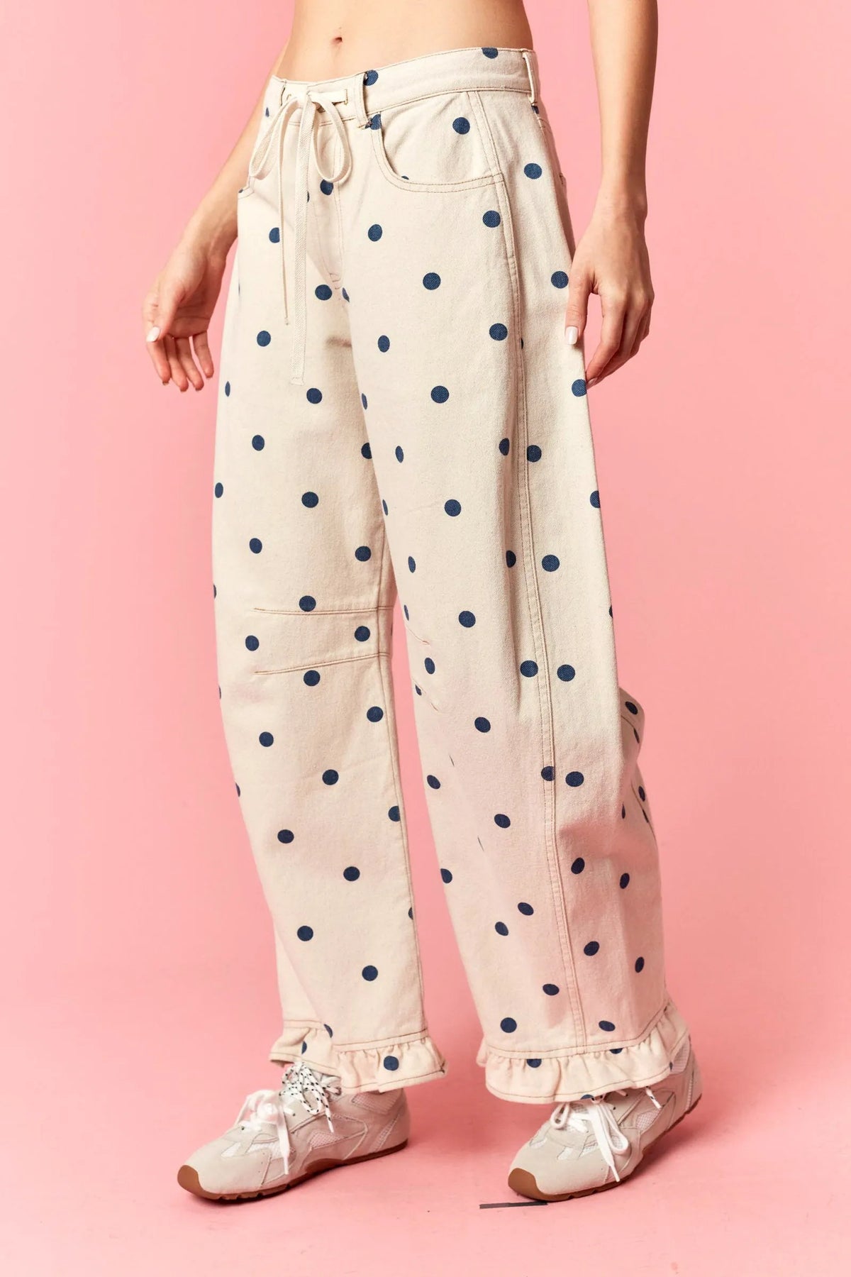Beige polka dot print barrel twill pants with navy blue dots and ruffle hem wide-leg design