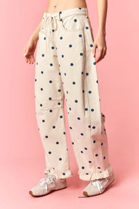 Beige polka dot print barrel twill pants with navy blue dots and ruffle hem wide-leg design