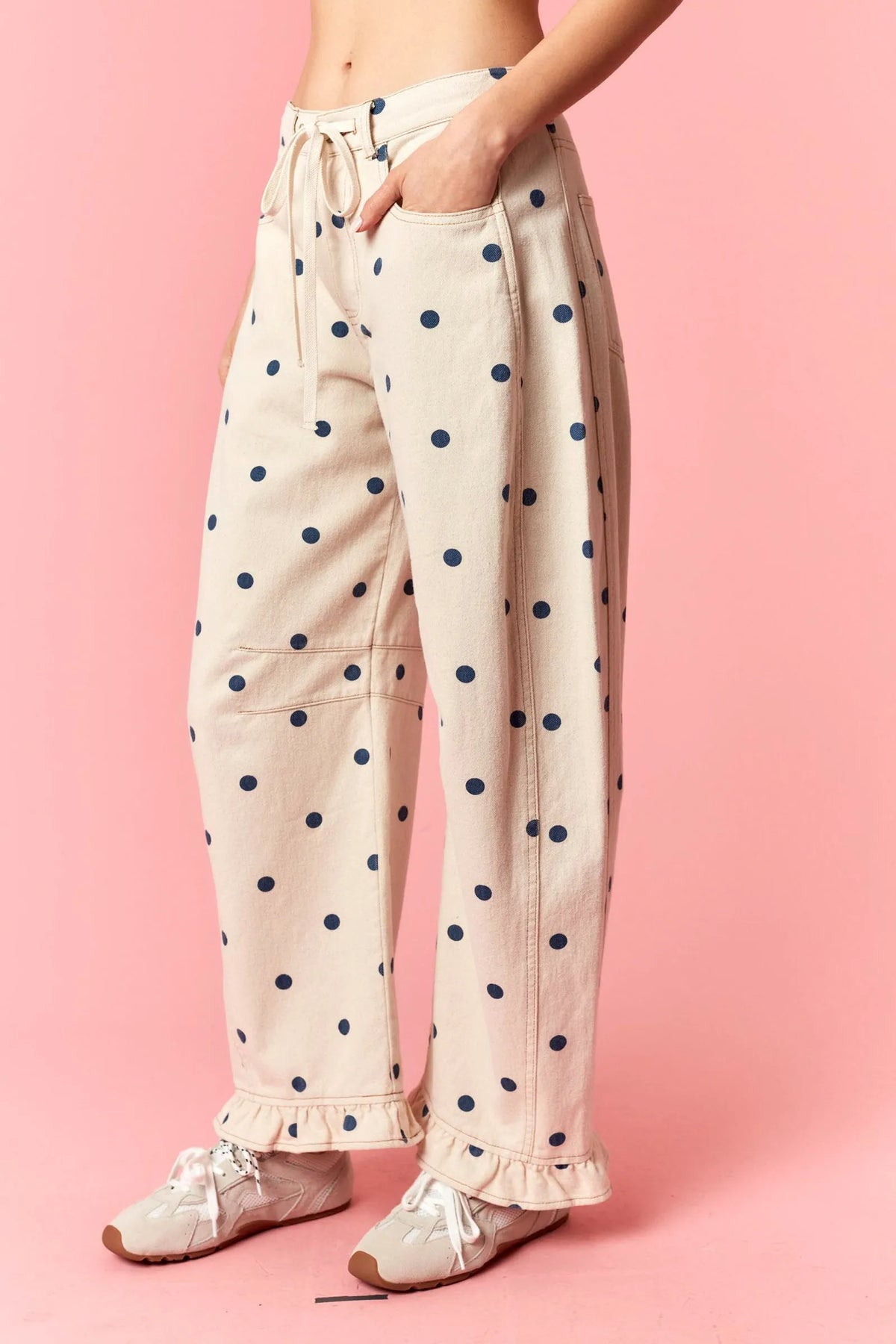 Beige polka dot print barrel twill wide-leg pants with navy blue dots and ruffle hem cuffs