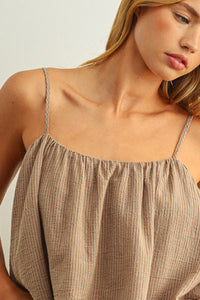 Beige ribbed cotton camisole with thin textured straps featuring a striped pattern spaghetti strap design