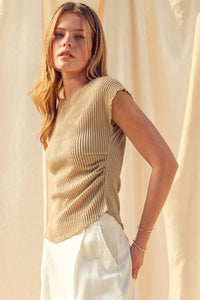 Beige ribbed knit sleeveless top with draped front detail featuring crinkled fabric shirring for textured style