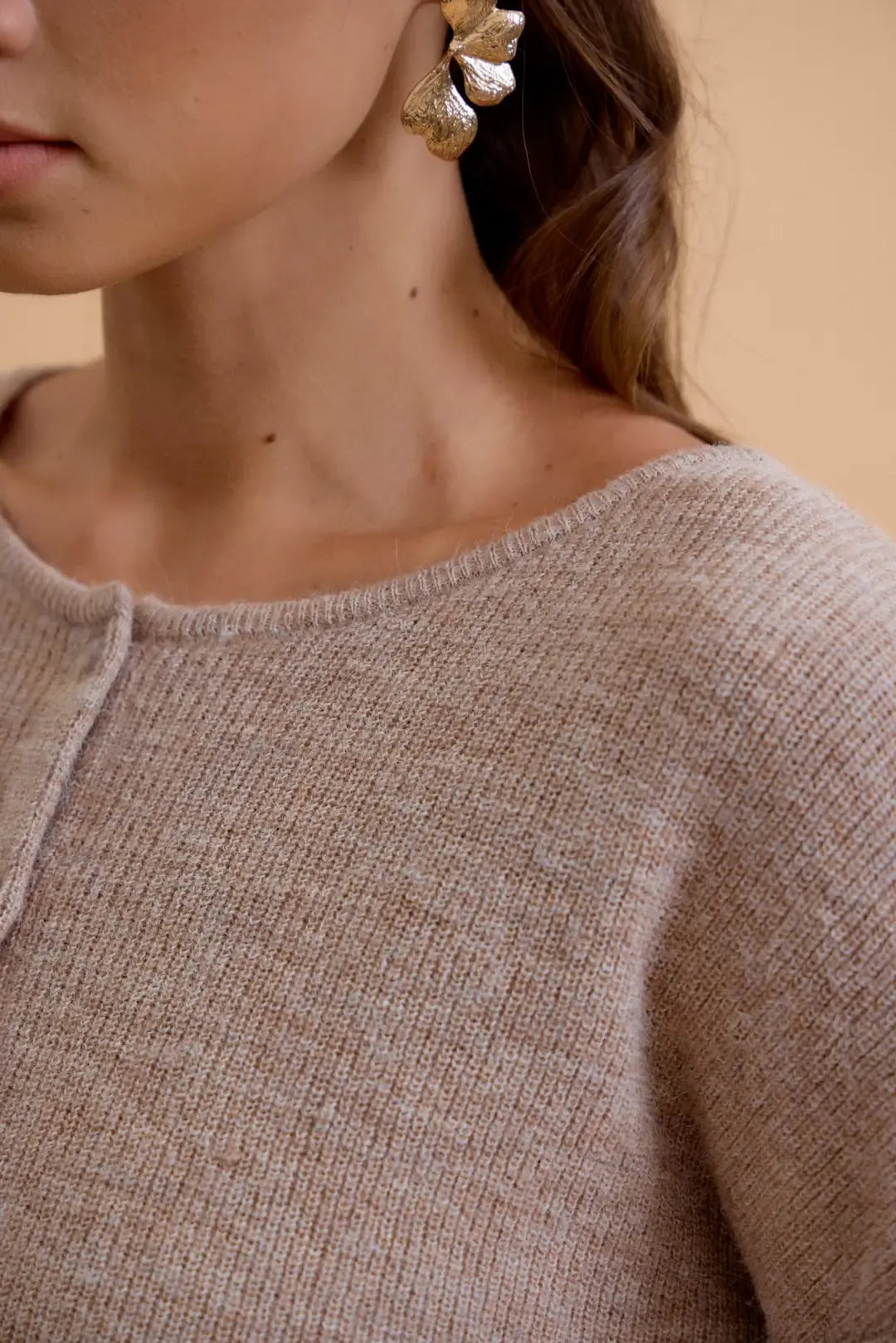 Beige wool ribbed cardigan with soft textured fabric and subtle v-neckline in round neck wool style
