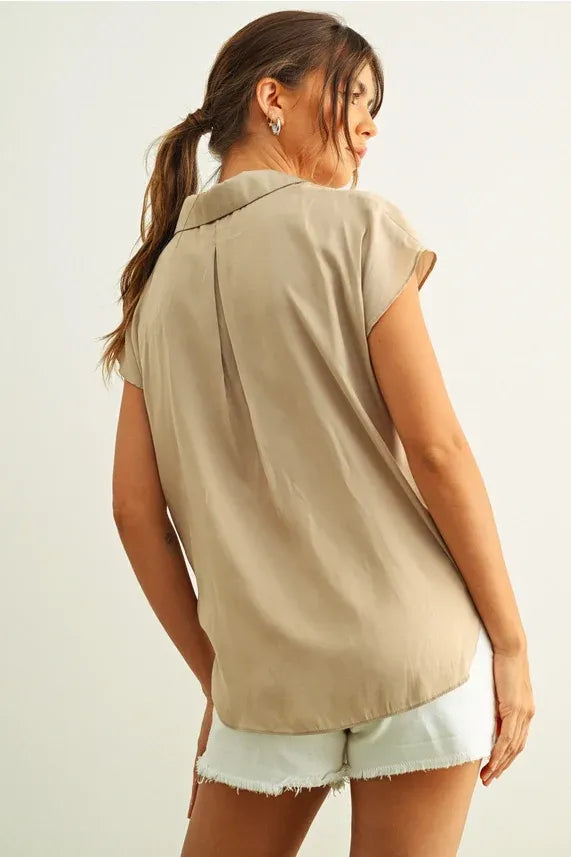 Beige lightweight button down cap sleeve shirt with a relaxed fit and subtle pleats at the back side