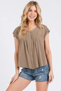 Beige short-sleeved blouse with pintuck detailed button front and relaxed fit perfect for casual wear