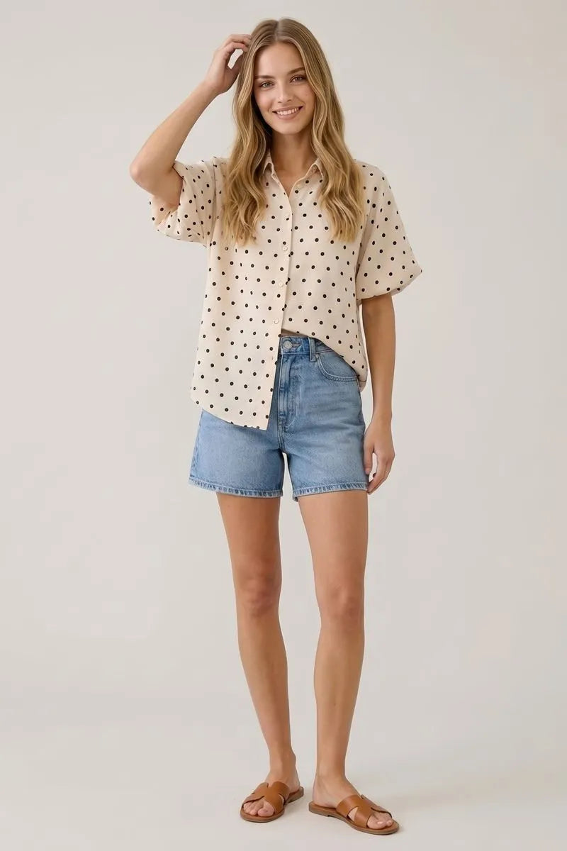 Beige short-sleeved polka dot bubble sleeve blouse with black dots and button-up front for casual wear