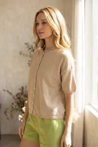 Beige short sleeve pointelle knit cardigan with subtle dot pattern and ribbed cuffs in lightweight material