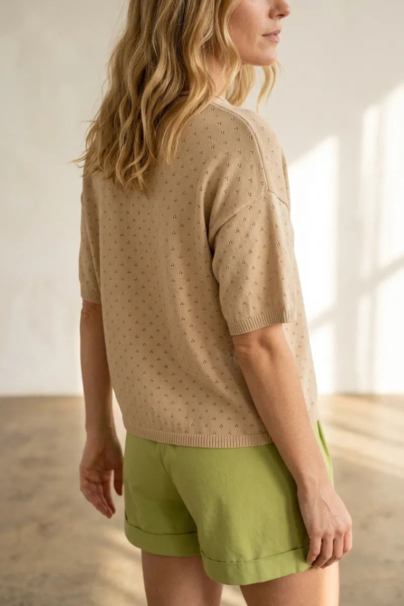 Beige short sleeve pointelle knit sweater with a subtle pattern of small dark dots in lightweight fabric