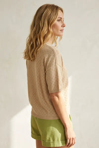 Beige short sleeve pointelle knit sweater with subtle dot pattern and ribbed cuffs in lightweight material