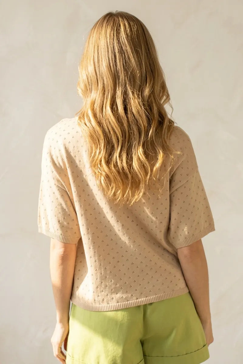 Beige short sleeve pointelle knit sweater with subtle dark dot pattern in lightweight breathable material