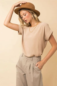 Beige short roll up sleeve top with relaxed fit and subtle texture in women’s boho chic clothing shop daisy collection