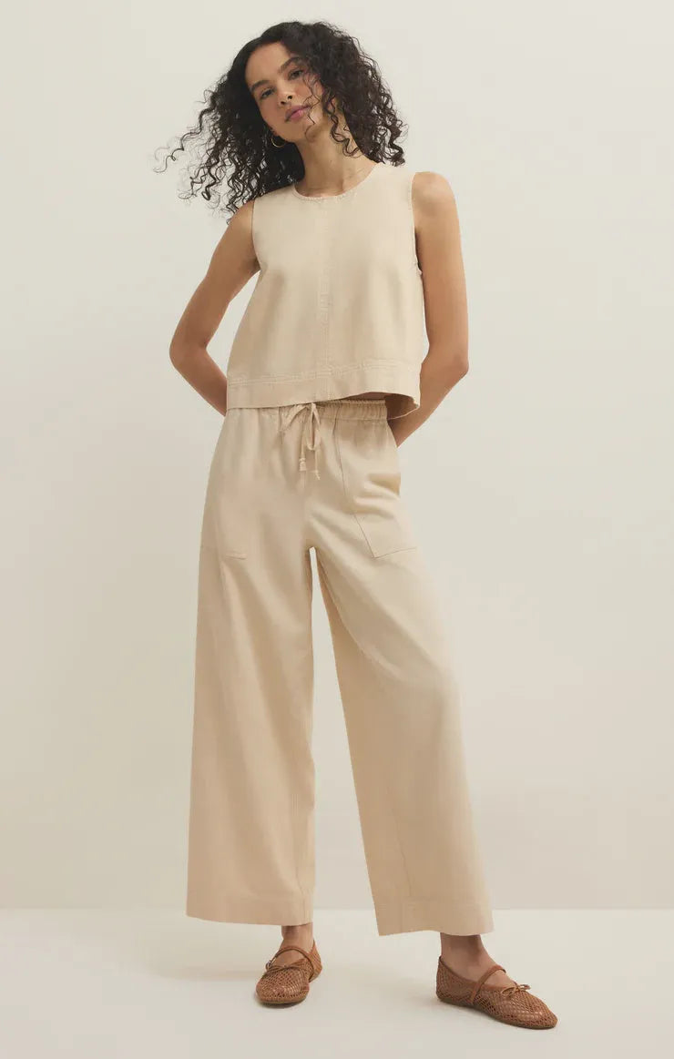 Beige sleeveless cropped top with relaxed fit and subtle drawstring waistband paired with twill wide leg utility pants