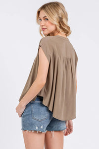 Beige sleeveless top with relaxed fit and gathered waistline featuring pintuck detailed button design