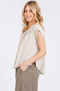 Beige sleeveless top with a relaxed draped silhouette and subtle front pintuck detailed button pleats