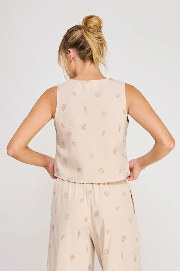 Beige seashell lace embroidered woven sleeveless top with subtle metallic leaf and circle patterns