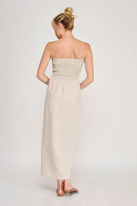Beige strapless maxi dress with smocked bodice and flowing fabric featuring convenient side pockets maxi dress