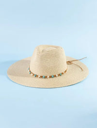 Beige straw hat featuring turquoise and brown starfish beads decorative band in starfish beads straw hat style