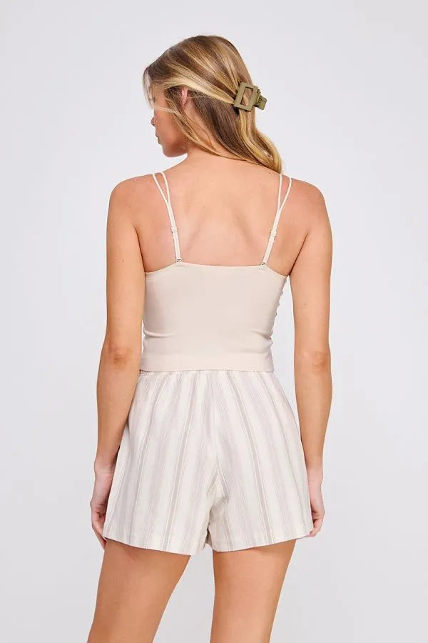 Beige and white vertically striped romper with thin spaghetti straps paired with fine lace pattern scallop bralette with scalloped edges