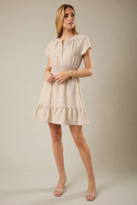 Beige and white vertically striped mini dress with notch neck short sleeves smocked waistband and tiered skirt