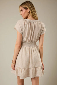 Beige and white vertically striped mini dress with notch neck short sleeve, gathered waistband, and ruffled hemline in soft fabric