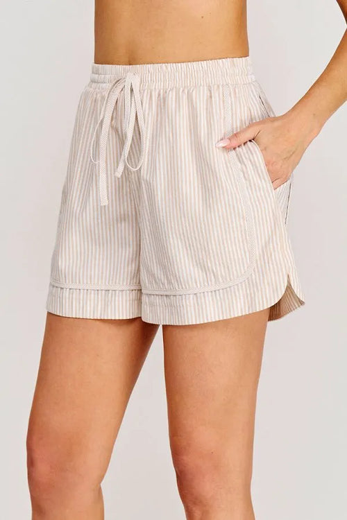 Beige and white vertically striped shorts with tie elastic waist, pockets, drawstring tie, and rolled hem for casual wear