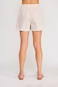 Beige and white vertically striped cotton shorts with rolled cuffs featuring a tie elastic waist and elastic waist pockets